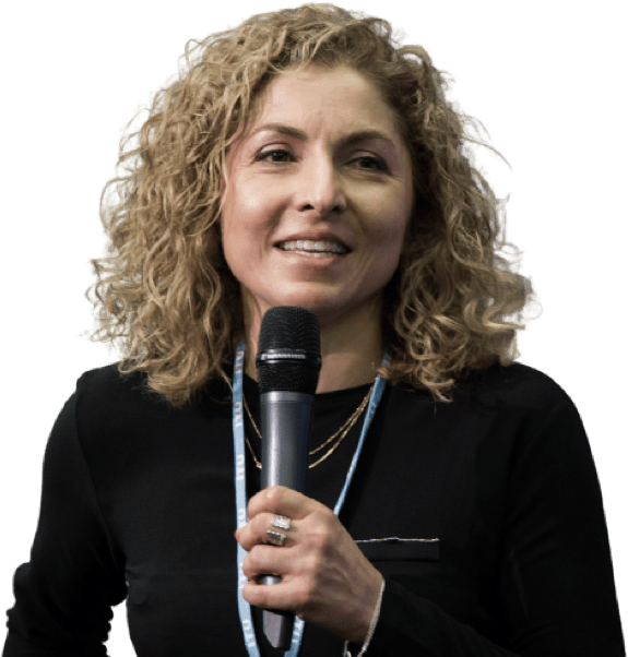 Anousheh Ansari smiling and holding a microphone